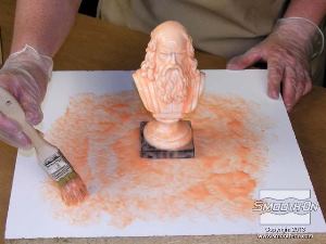 לחיצה להגדלת תמונה מכסים את כל המודל בשכבה הראשונה של סיליקון RTV למריחה  Rebound® 25 . מורחים חומר גם על לוח הבסיס מסביב למודל במרחק של כ7.5 ס