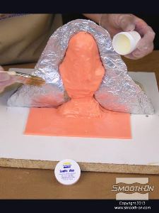 לחיצה להגדלת תמונה מורחים שכבה נדיבה של חומר אטימה Sonite Wax על נייר האלומיניום ועל לוח הבסיס.