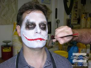 לחיצה להגדלת תמונה צובעים את השפתיים והצלקות באיפור אדום.