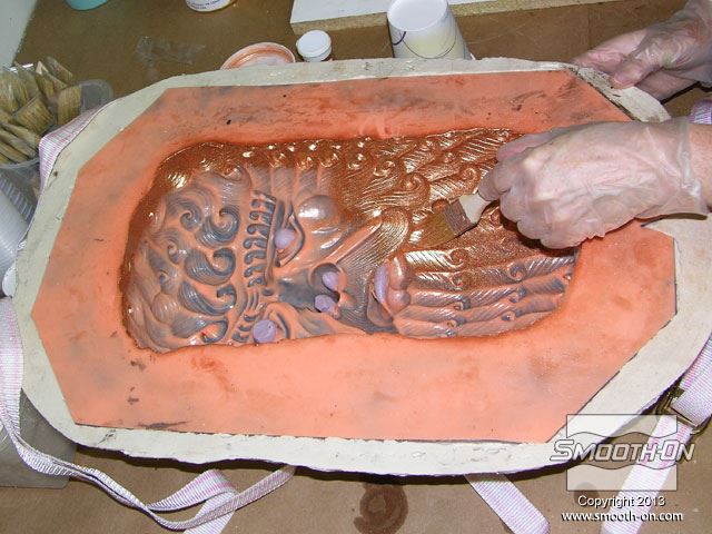 מורחים אבקת Cast Magic ברונזה על תבנית סיליקון למריחה Rebound 25 עם מעיל תמיכה מ פוליאוריתן קשיח Plasti-Paste. בליטות העיניים והנחיריים נעשו בקלות עם בצק סיליקון Equinox?