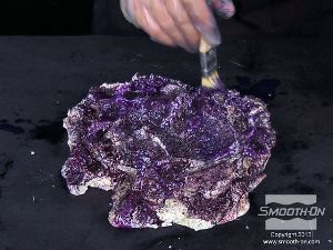 לחיצה להגדלת תמונה מורחים שכבות נוספות של פוליאוריתן Smooth-Cast® 325 בצבעים שונים על יציקת הסלע החי.