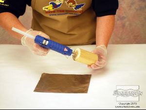 לחיצה להגדלת תמונה מדביקים את גליל העץ לנייר האלומיניום בעזרת דבק חם.